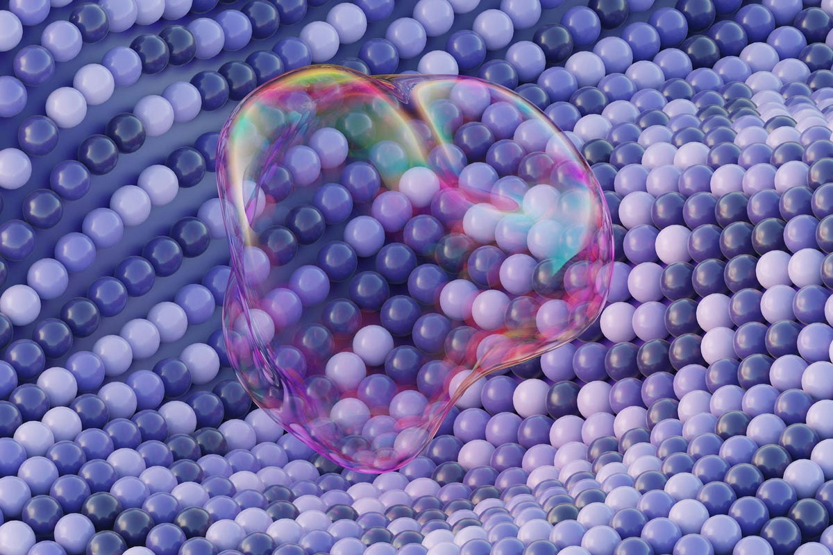 A translucent, bubble-like oval object with iridescent pink, purple, blue, and green tones sits on top of a dense field of small glossy purple and lavender spheres.